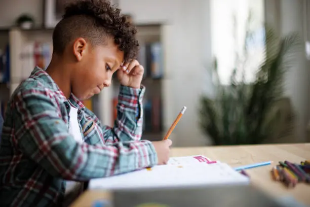 Child working on writing with a pencil