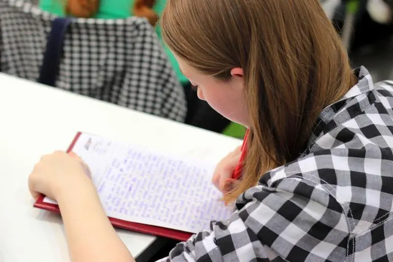 Student studying with pen and paper